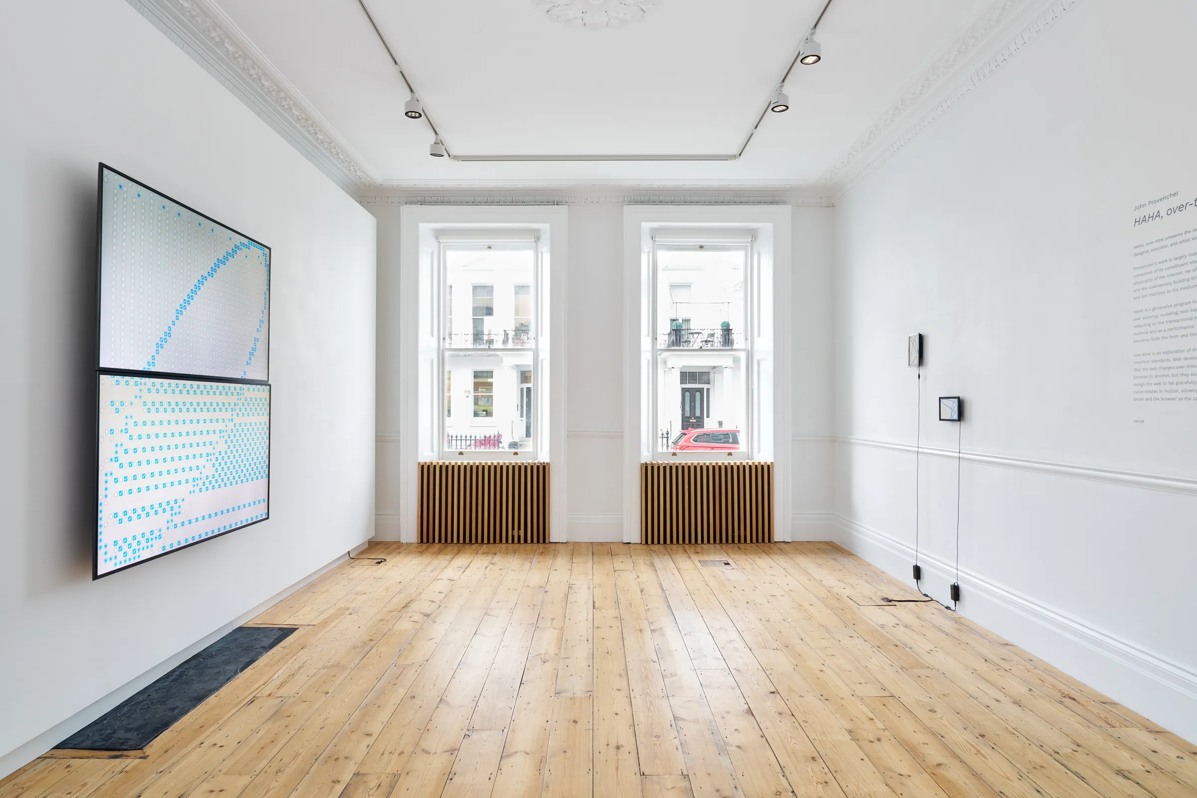 over-time gallery installation — blue lissajous artwork on left wall